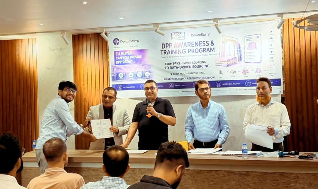 DeviceStamp DPP awareness and training program in Bangladesh: team members with the program banner, speaker addressing the audience